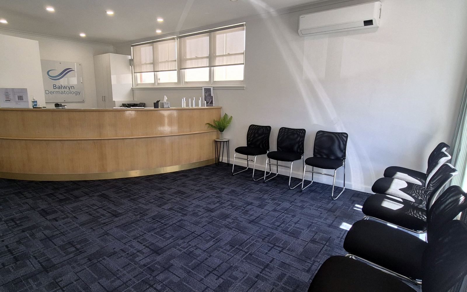 The reception desk and waiting area, with chairs along the wall